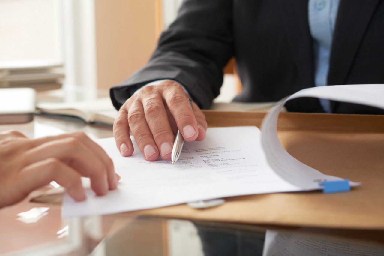 A man signing a business contract. Photo/Adobe Stock