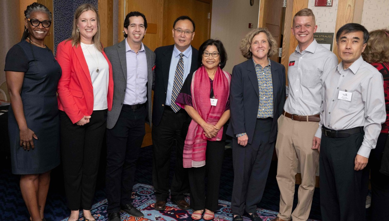 Male and female accounting professors, staff members and Dean Marianne Lewis pose for a picture in professional dress.