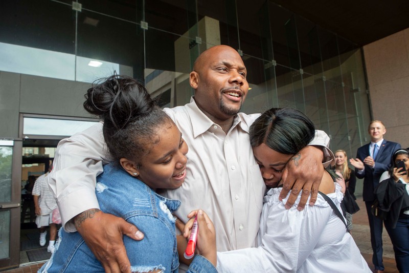 OIP Exoneree hugs his daughters