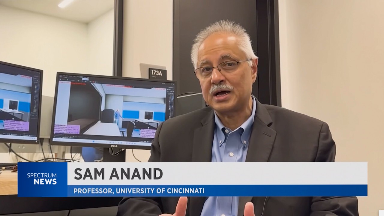 Sam Anand speaks to Spectrum News with a Spectrum News logo on the screen.