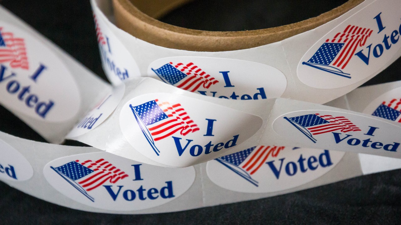 A roll of I voted stickers with American flags.