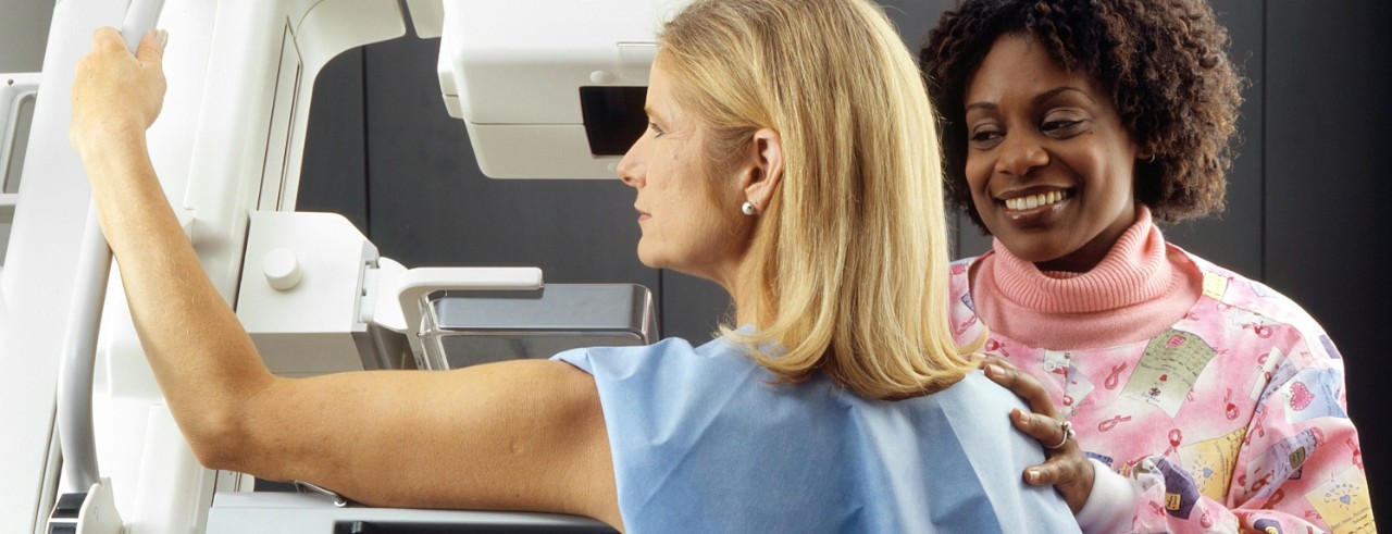 A woman receives a mammogram 