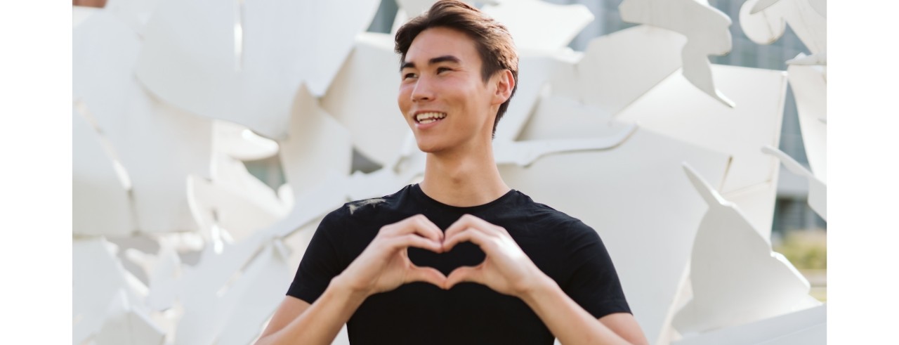 UC student making a heart with his hands