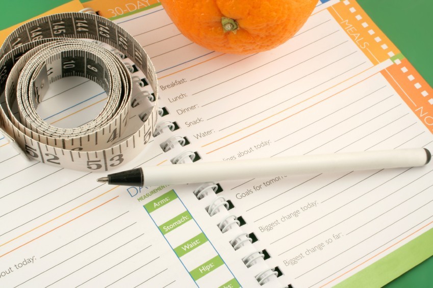 Diet journal with pen and tape measure