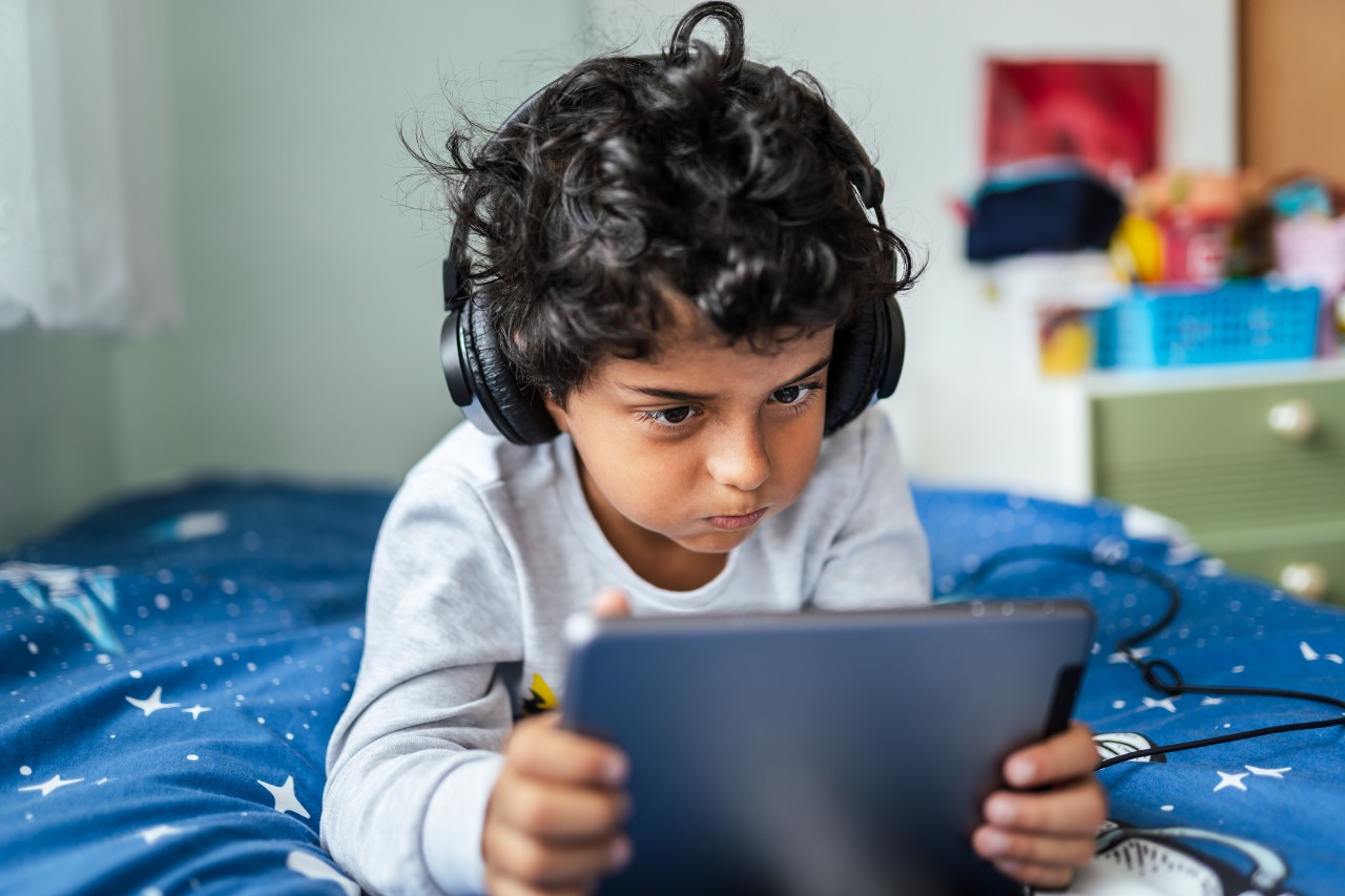 child watching something on a laptop device