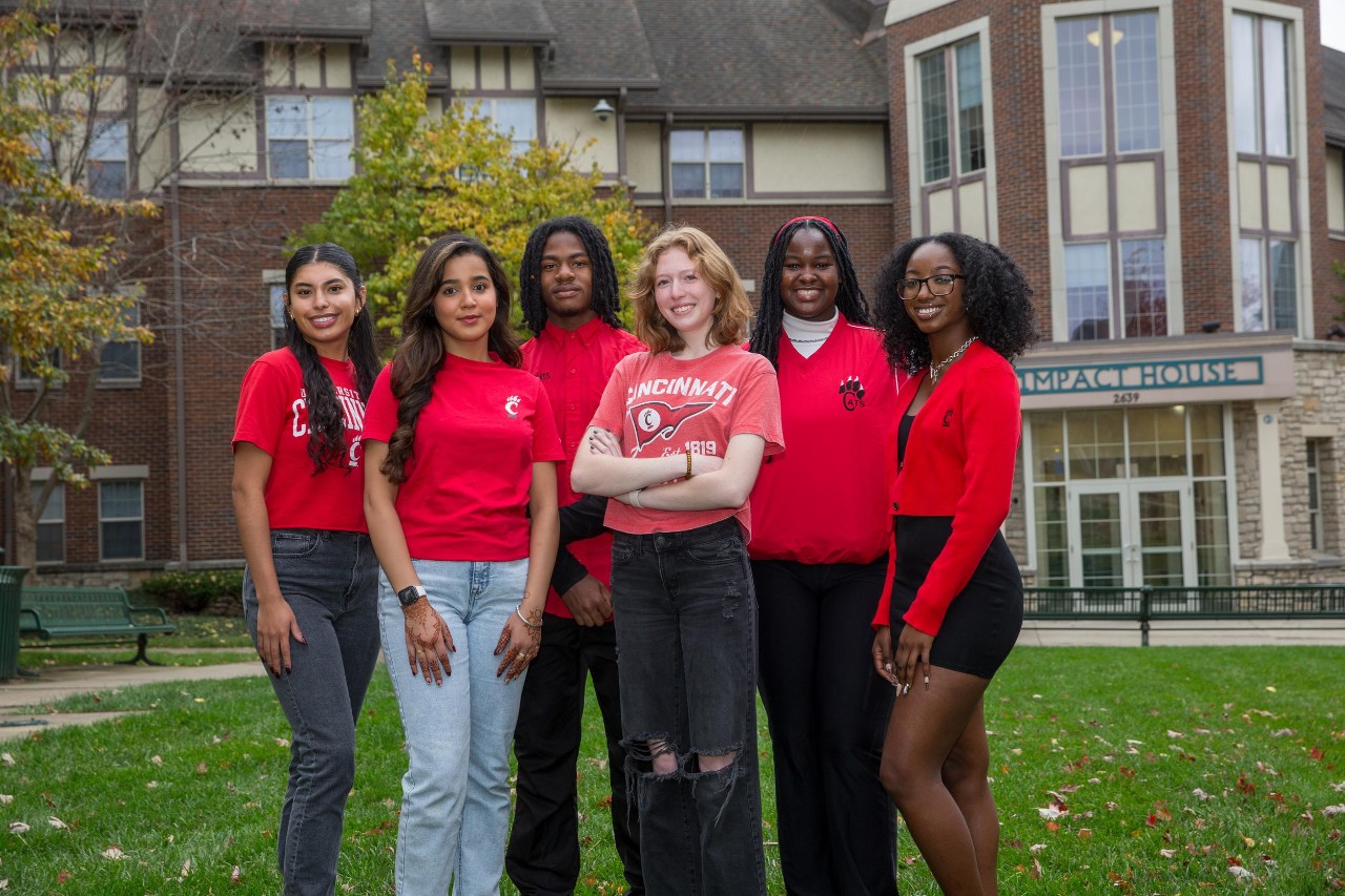 six UC students posse for photo outside of the Impact House on campus