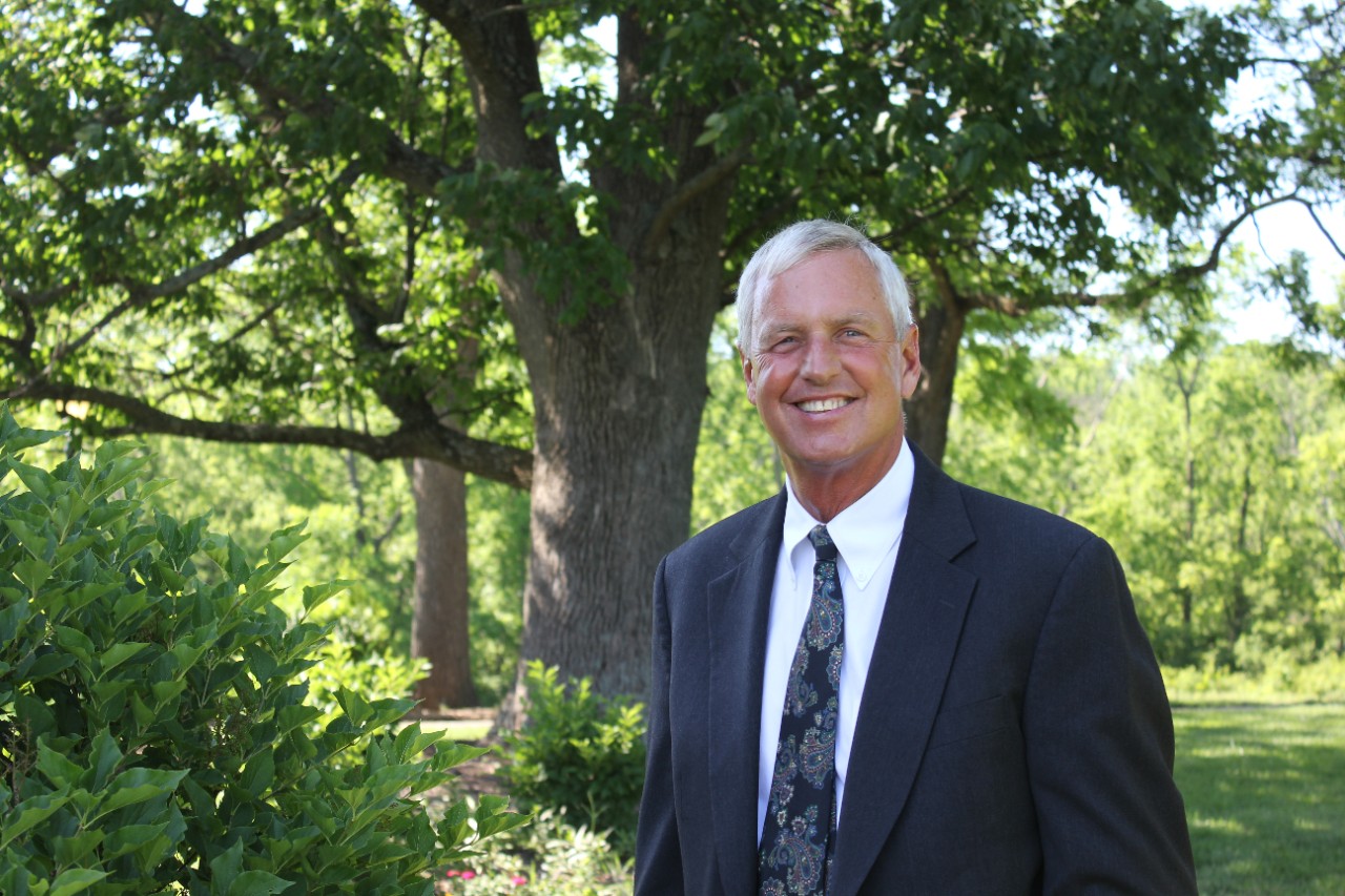 Greg Lawton wearing a suit outside.