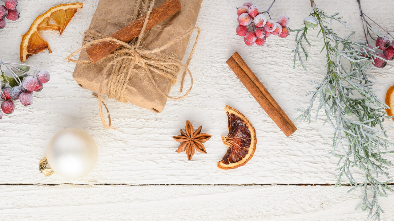 group of holiday items including gift, ornament, oranges and cranberries