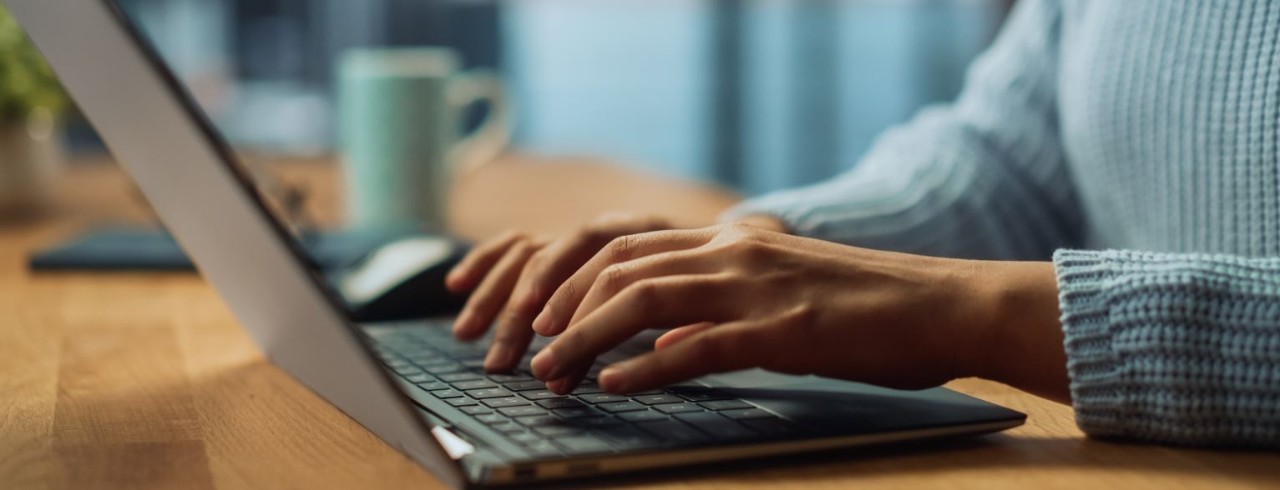 someone typing on a laptop computer