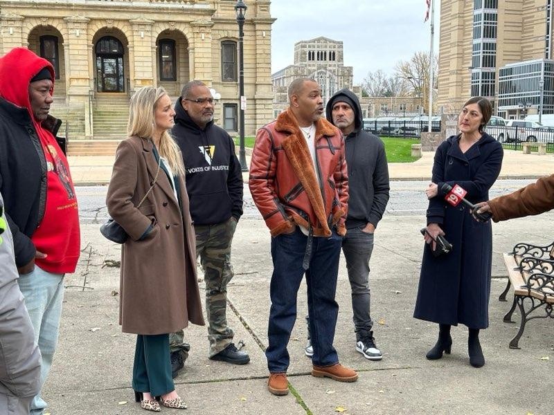 Al Cleveland, in the black sweatshirt, and Lenworth Edwards, in the black and red jacket, speaking to media at last Monday's rally in Elyria, Ohio.