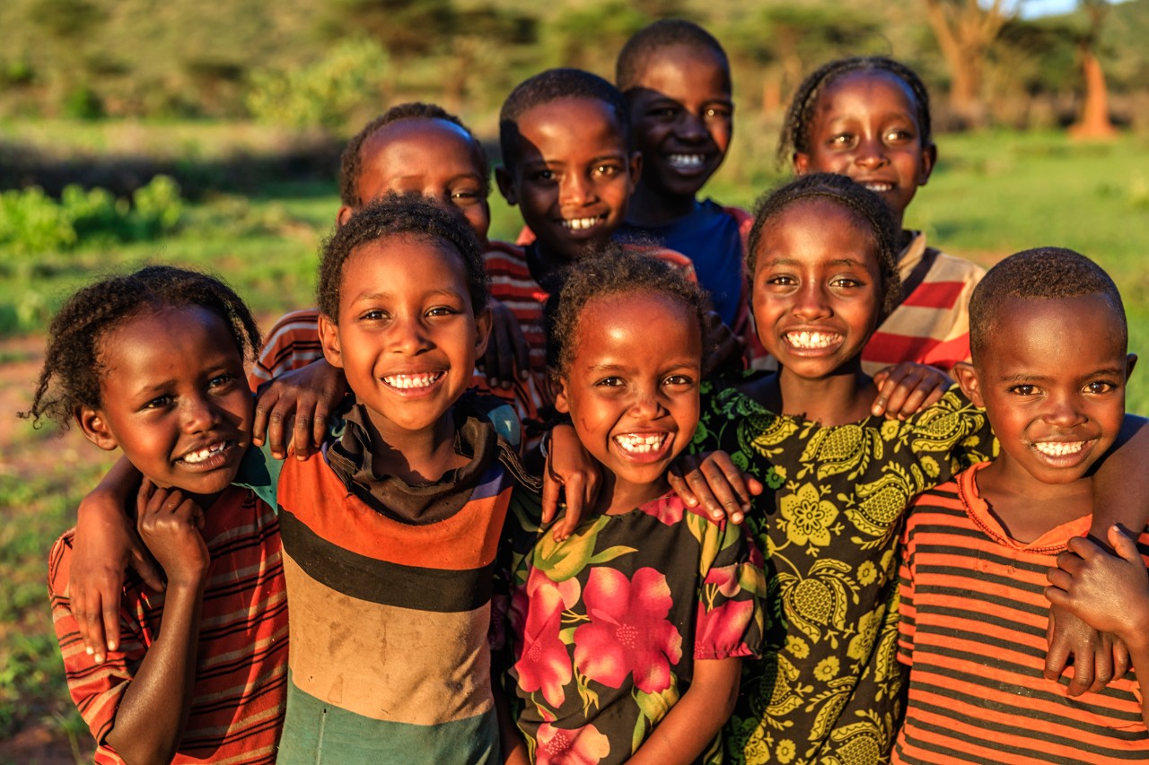 A group of children smiling and looking happy in eastern Africa.