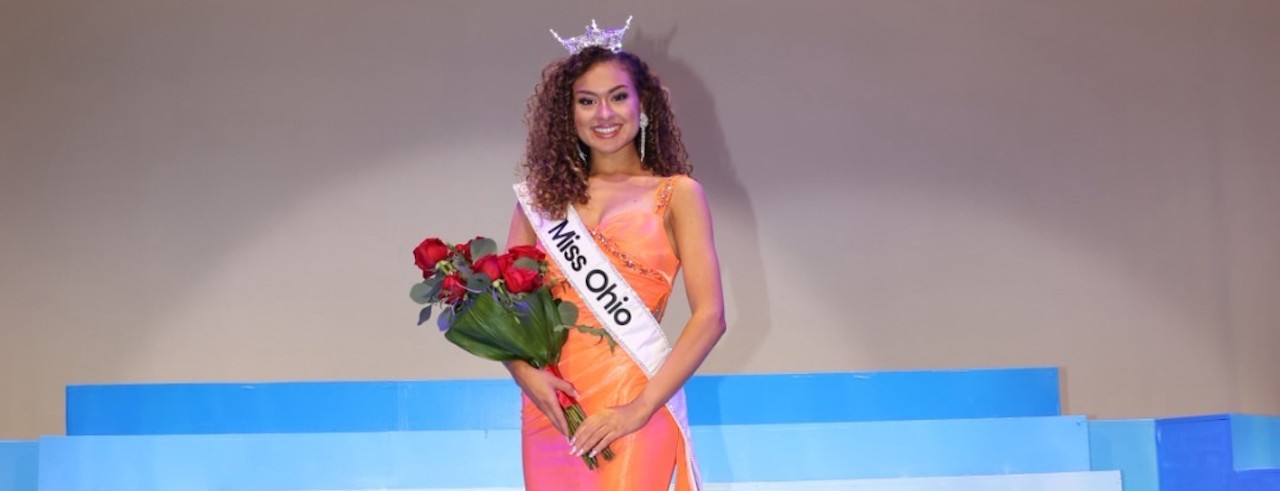 Stephanie Finoti holds a bouquet of flowers while wearing her sash and crown for Miss Ohio.