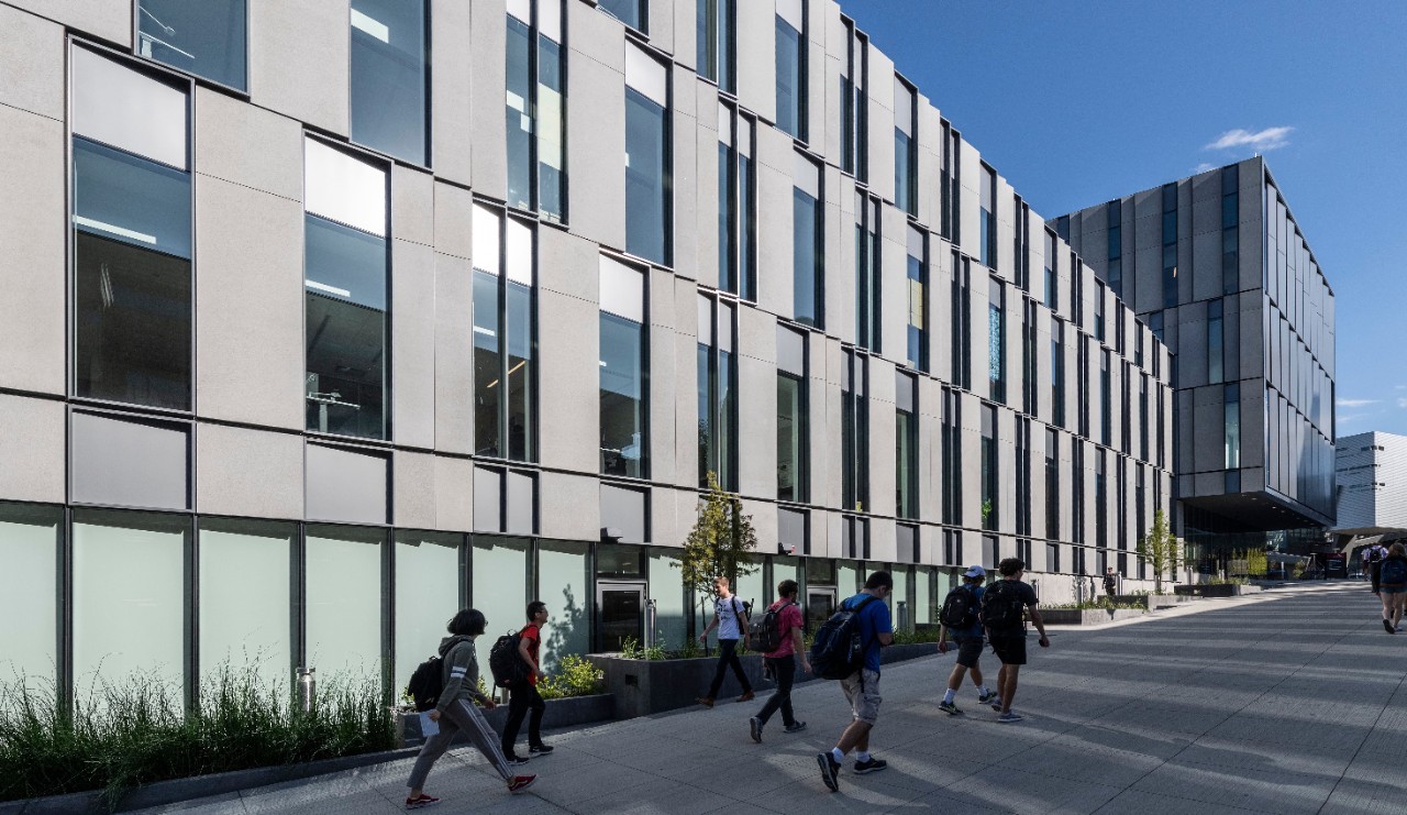 The exterior of Lindner Hall with students walking by in the foreground.