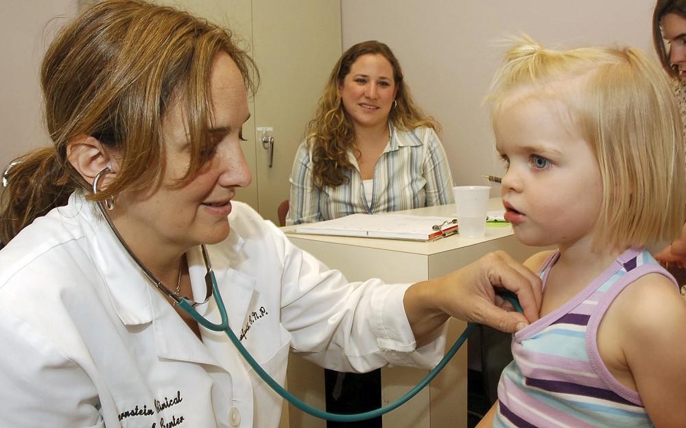 Nurse practitioner Sherry Stanforth (left) listens to a Cincinnati Childhood Allergy and Air Pollution Study participantÂ s breathing during a regular check-up. 