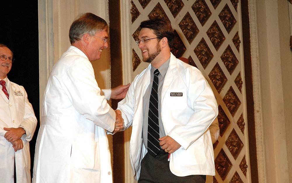 Brad Besson (right) is congratulated by his father, UC alumnus Michael Besson, MD, during the 2007 White Coat Ceremony.