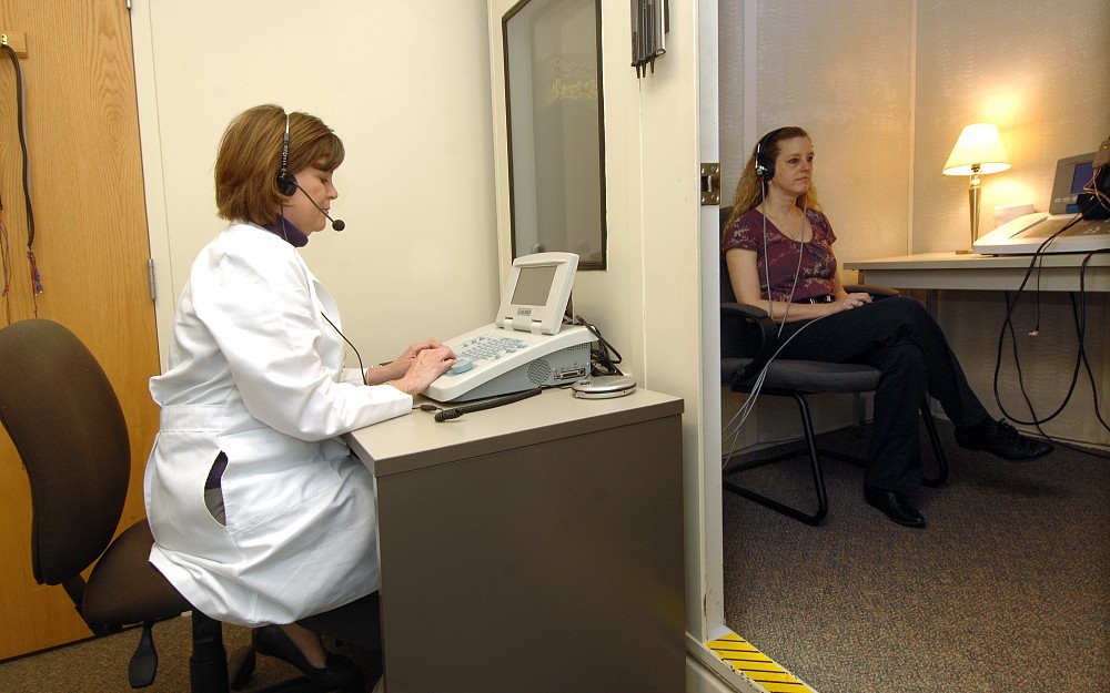Stephanie Lockhart, director of audiology, conducts a screening to test for hearing loss.