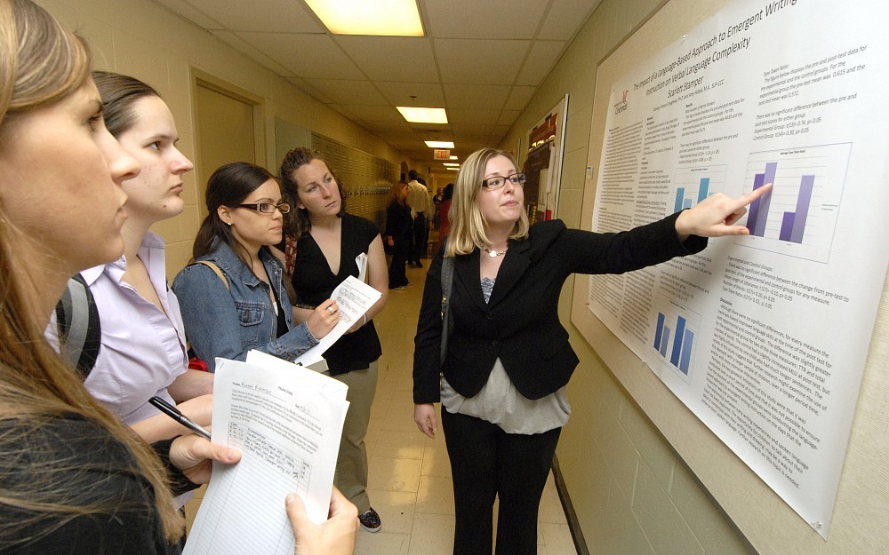 Scarlett Stamper shows her research to faculty, fellow students and visitors at the 13th annual Presentations of Research and Innovative/Scholarly Endeavors (PRaISE) conference, held Friday, May 20, at the College of Allied Health Sciences.
