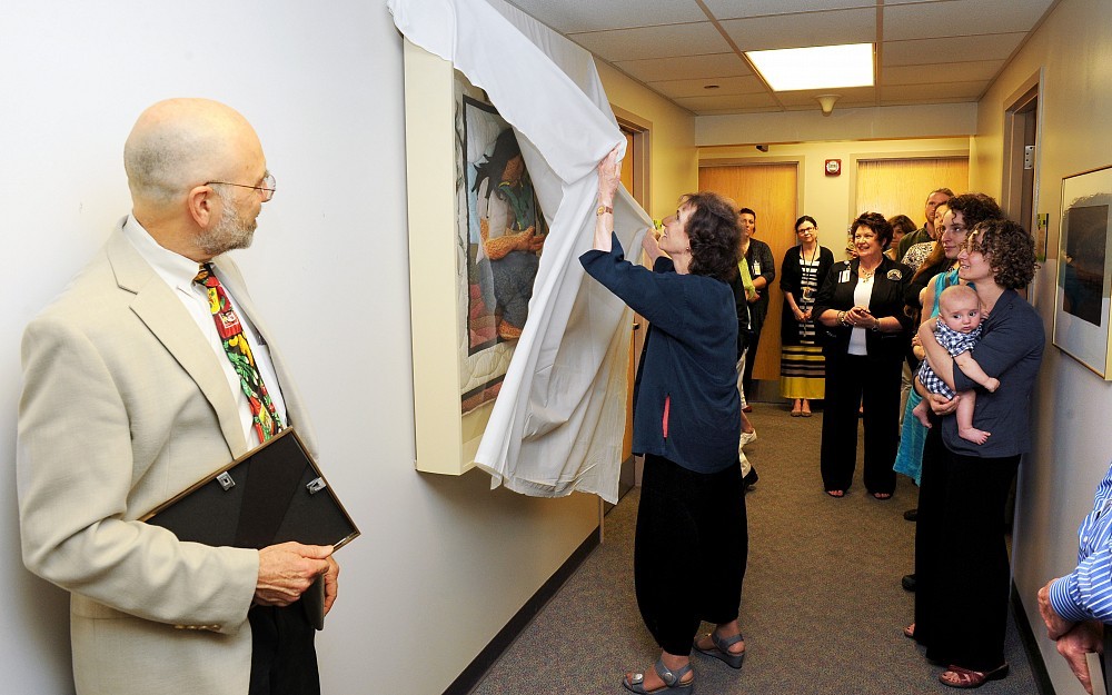 Laura Wexler, MD, adjunct professor of internal medicine in the division of cardiovascular diseases, unveils the quilt during a ceremony at Cincinnati Children's Hospital Medical Center June 19.
