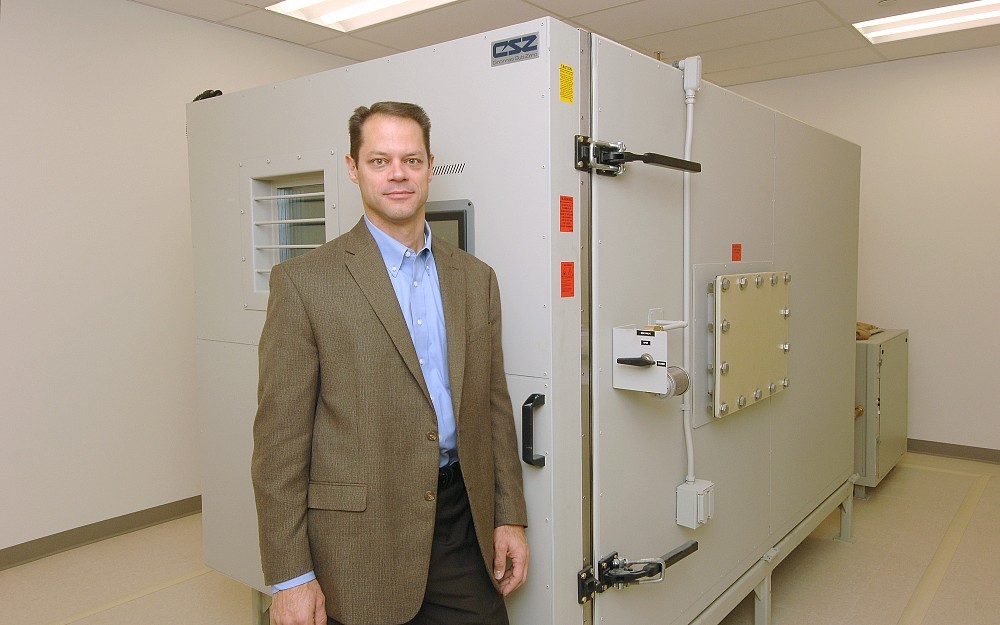 Alex Lentsch, PhD, director of the UC Institute for Military Medicine by the new research altitude chamber at UC Reading Campus.