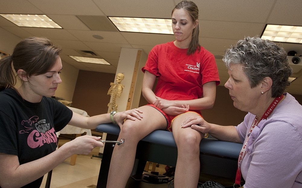 Rebecca "BeckyÂ  Rebitski works with doctorate of physical therapy students at the College of Allied Health Sciences.