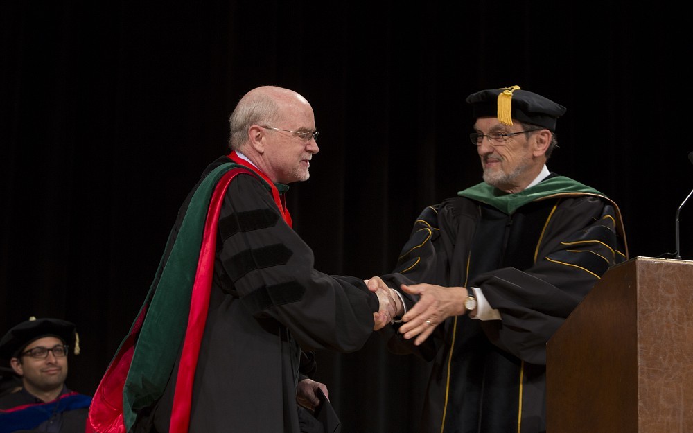 College of Medicine Dean Thomas Boat, MD (right), congratulates 2014 Daniel Drake Medal winner John O'Shea Jr., MD.
